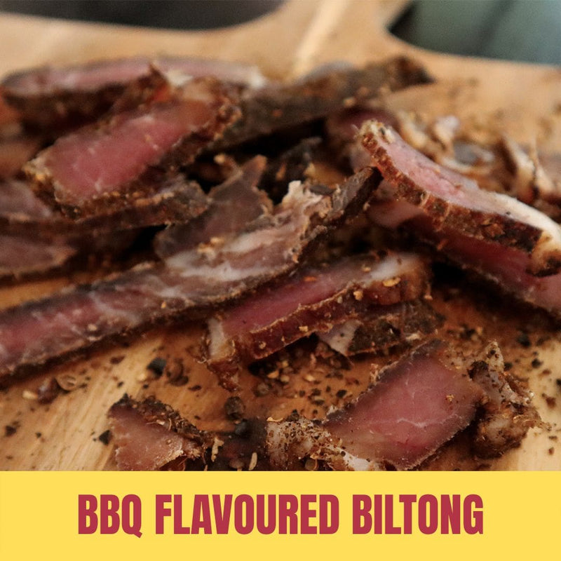 Sliced BBQ flavoured biltong on a wooden board with 'BBQ Flavoured Biltong' text.