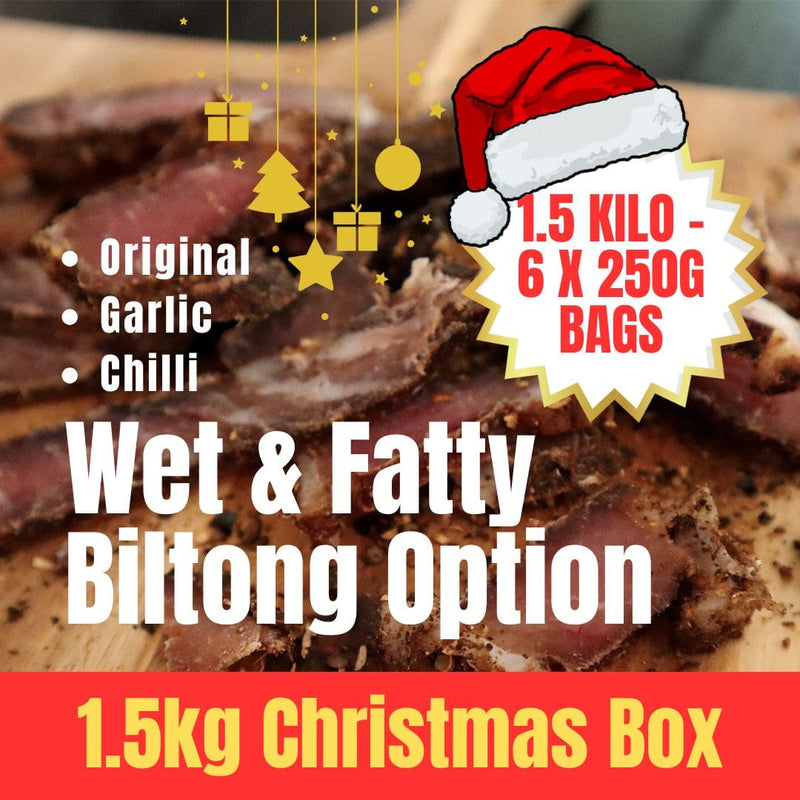 Biltong with a Santa hat and Christmas-themed text on a wooden surface showing 1.5 kilo of wet & fatty biltong