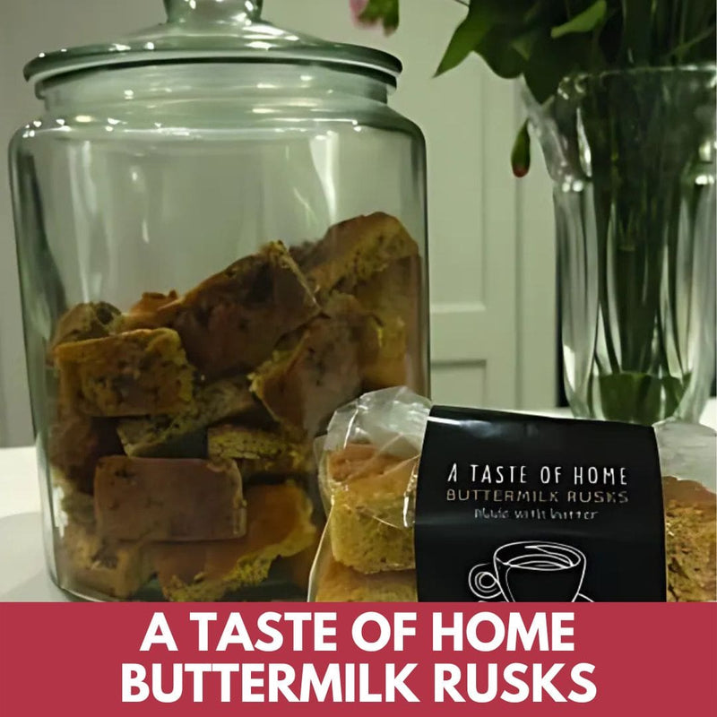 Jar of buttermilk rusks with a package labeled 'A Taste of Home Buttermilk Rusks' on a white surface.
