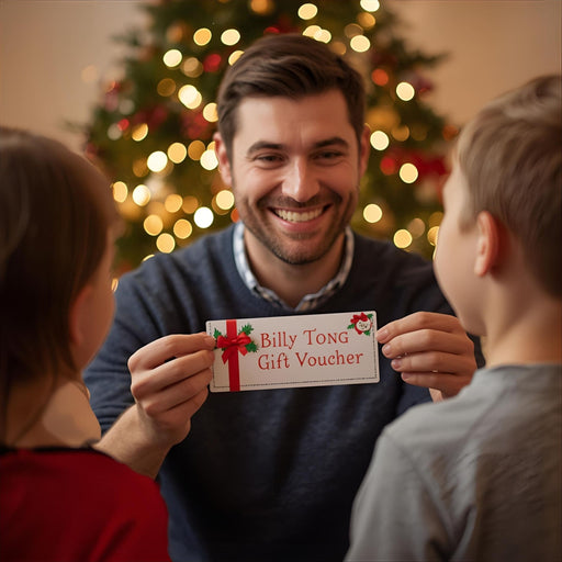 Man holding up a Billy Tong Gift Voucher in front of a Christmas Tree