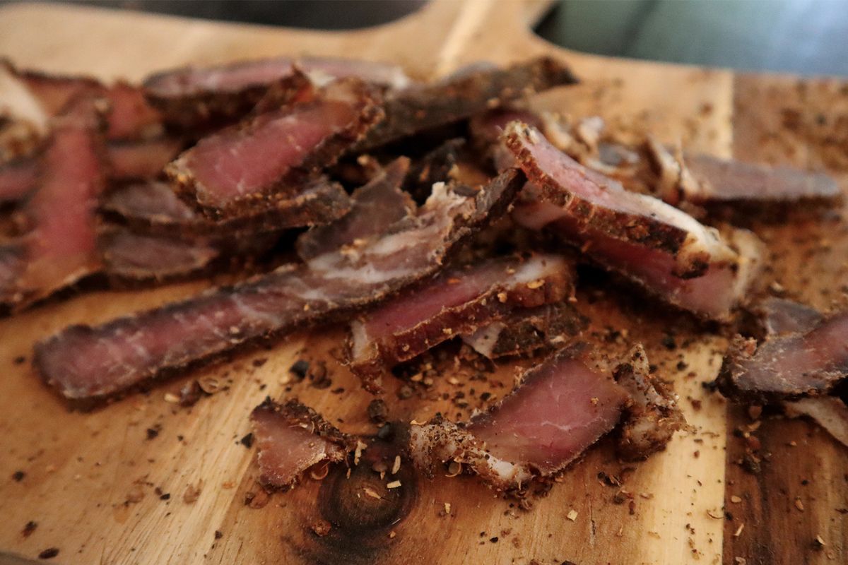 Slices of Biltong on a wooden cutting board