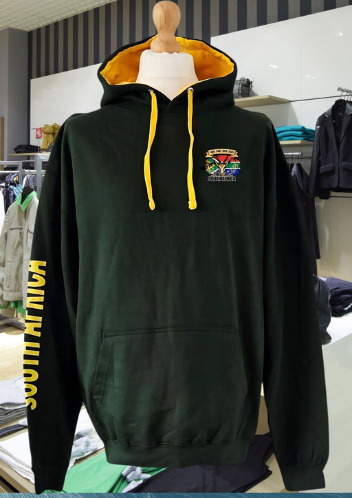 Boerkraal Rugby Heritage Green hoodie with yellow drawstrings and South African Rugby Motif on a mannequin in a store setting.