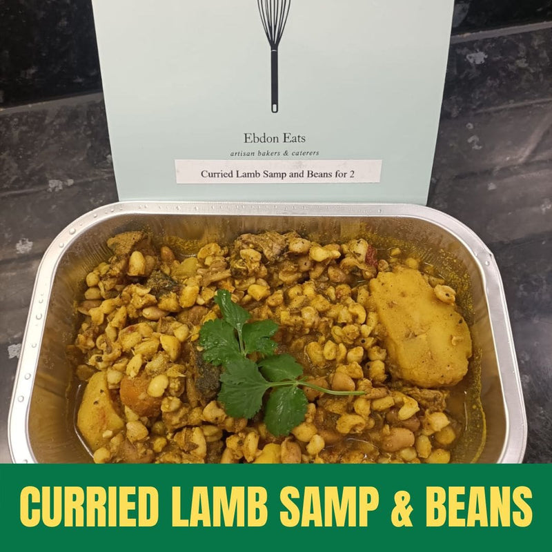 Container of curried lamb samp and beans with 'Eldon Eats' branding on a dark surface.