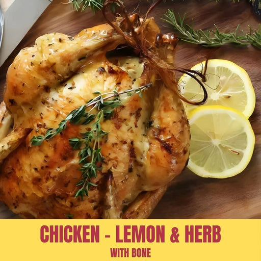 Roasted chicken with lemon and herbs on a wooden board