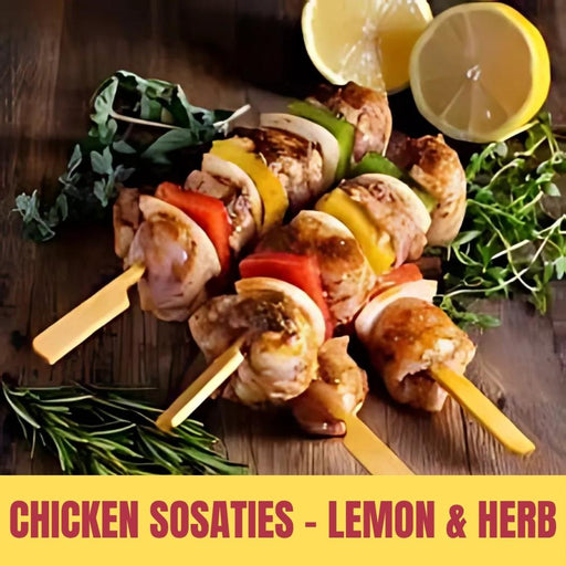 Chicken Sosaties skewers with lemon and herbs on a wooden surface