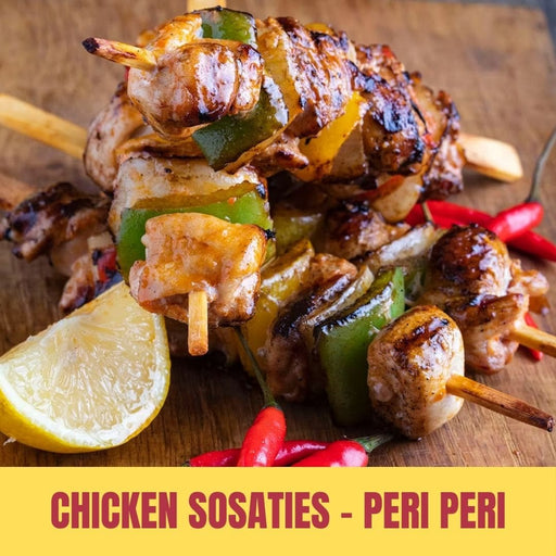 Grilled chicken sosaties with vegetables on a wooden board, accompanied by lemon and red peppers, with text 'Chicken Sosaties - Peri Peri'.