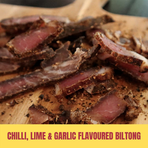 Sliced chili, lime, and garlic flavoured biltong on a wooden board with a yellow text overlay.