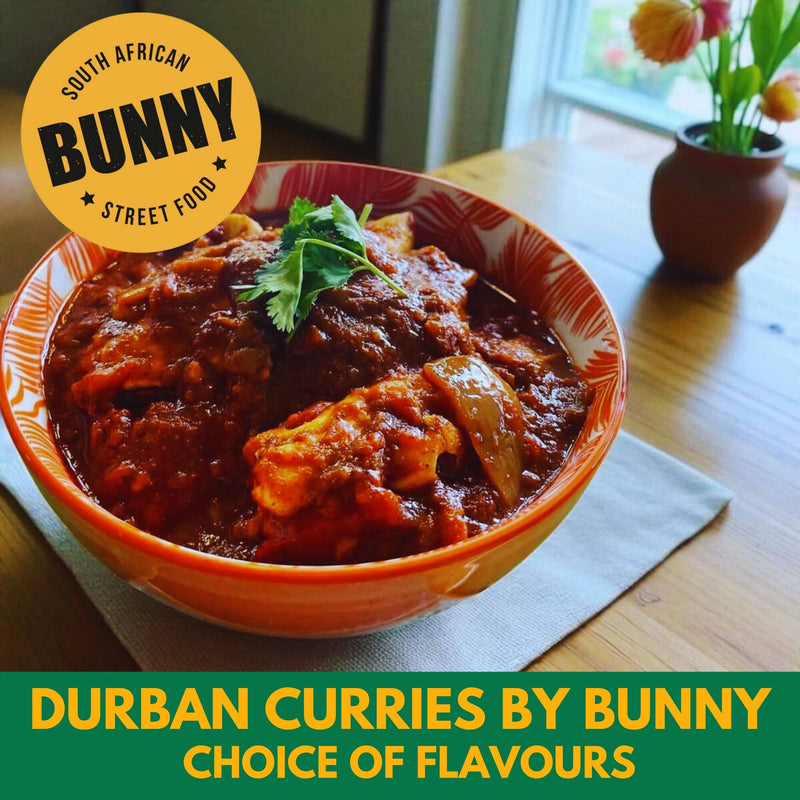 Bowl of Durban curry with 'South African Bunny Street Food' branding on a table.