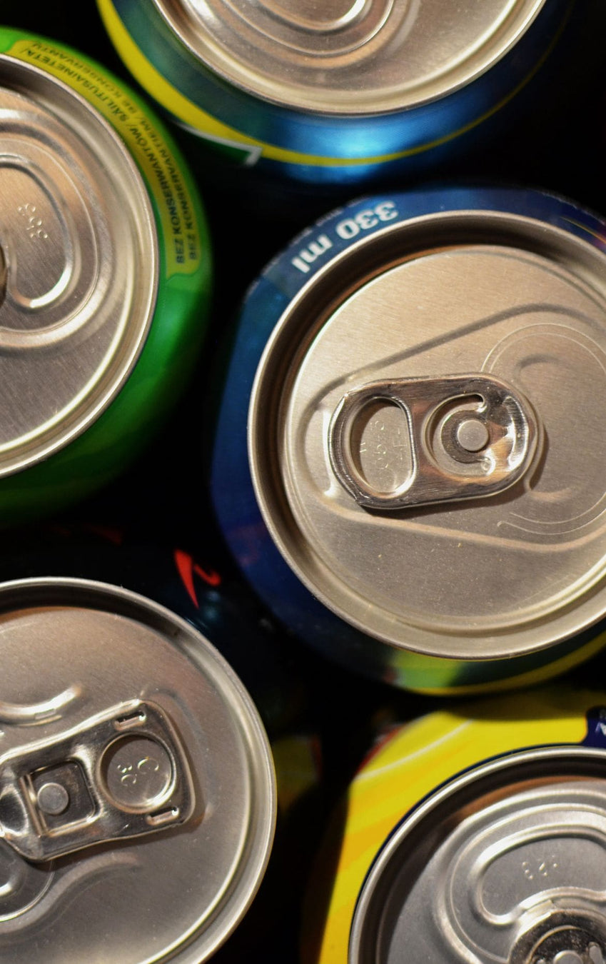 Close-up of multiple canned drinks with focus on the pull tabs. Drinks & Beverages from Billy Tong.