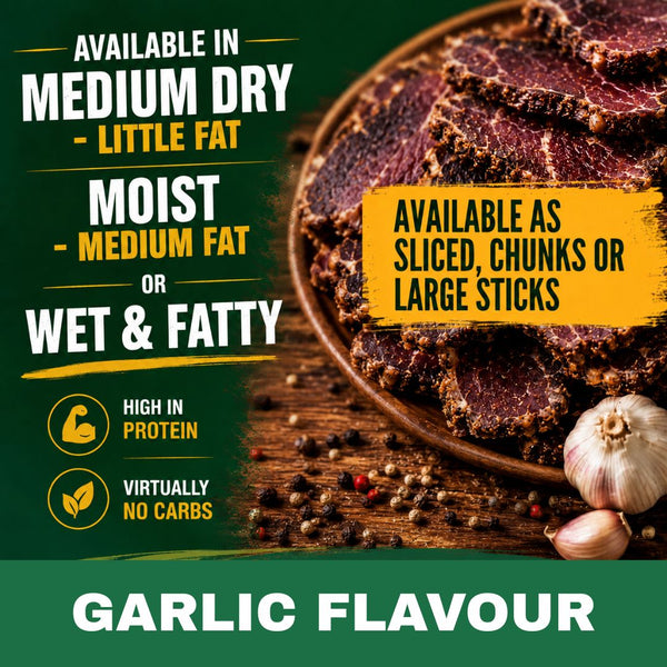 Promotional product graphic for garlic-flavour biltong. The image features a wooden bowl filled with sliced and chunky biltong, garnished with whole garlic bulbs and peppercorns on a rustic wooden table.