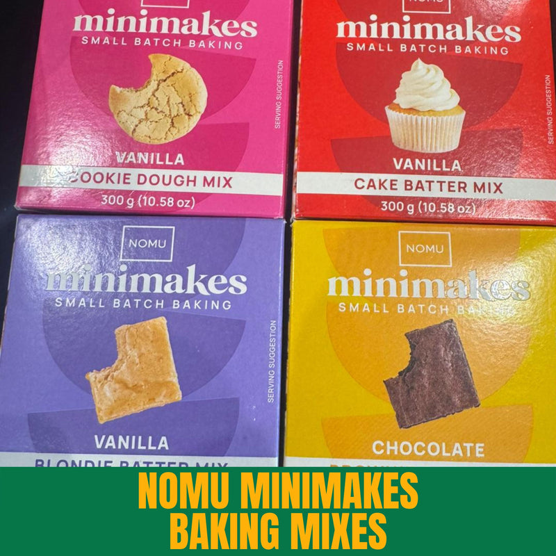 Four boxes of Nomu Minimakes baking mixes in different flavors on a green background.
