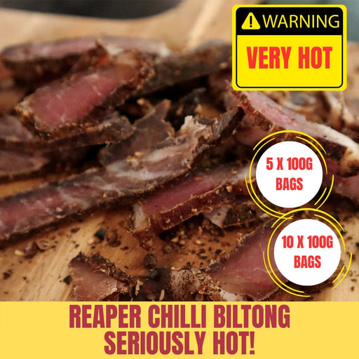 Reaper Chilli Biltong with a warning label and product details on a wooden surface.