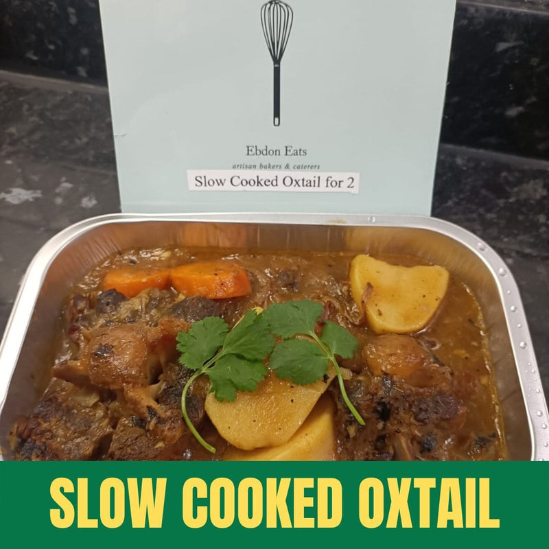Container of slow cooked oxtail with a branded box in the background