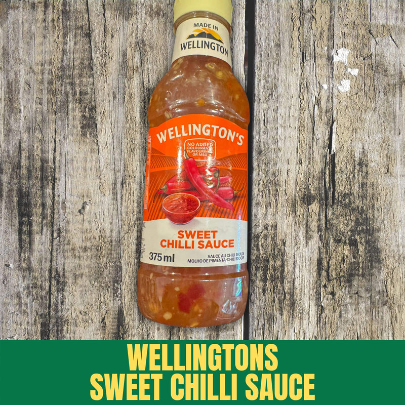 A bottle of Wellingtons Sweet Chilli Sauce on a wooden backround